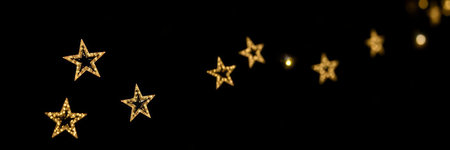 Christmas and New Year background. Golden stars on a black background.の写真素材