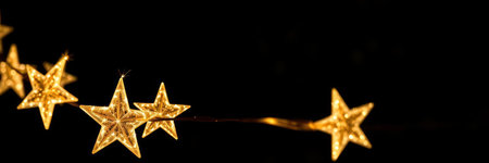 Golden stars on a black background. Christmas and New Year concept.