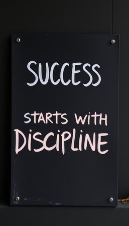sign with the text SUCCESS STARTS WITH DISCIPLINEの写真素材