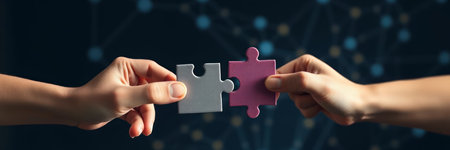 Close up of human hands connecting jigsaw puzzle pieces. Teamwork concept