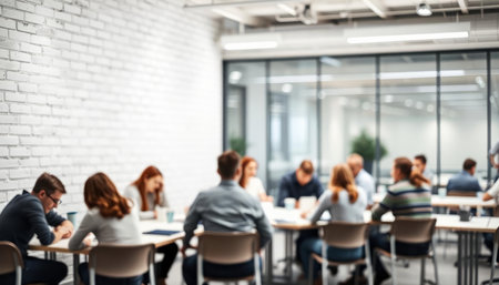 Blurred background of business people sitting at table during meeting in officeの写真素材