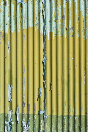 Light blue and yellow paint with scratch on the galvanized iron wall plate. background and textureの写真素材