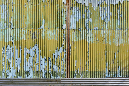 Light blue and yellow paint with scratch on the galvanized iron wall plate. background and textureの写真素材