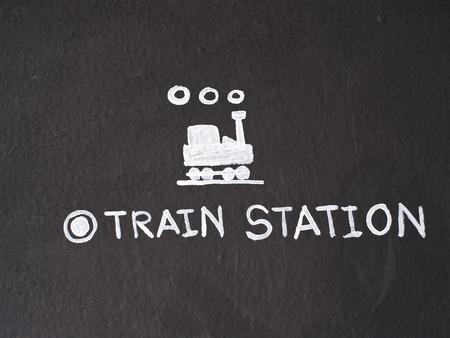 Train station sign draw on black cement wall.の写真素材