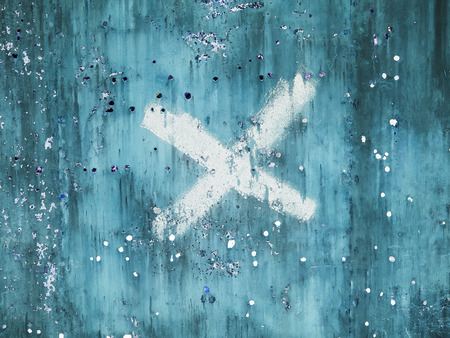 Old damaged metal surface with x letter.の写真素材
