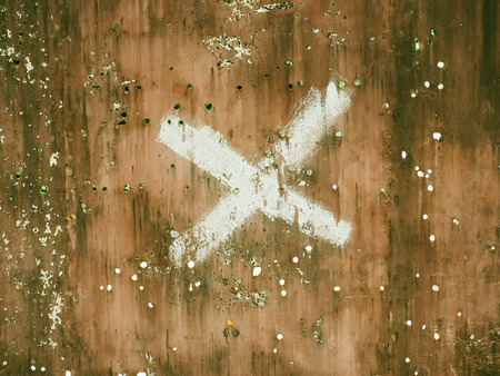 Old damaged metal surface with x letter.の写真素材