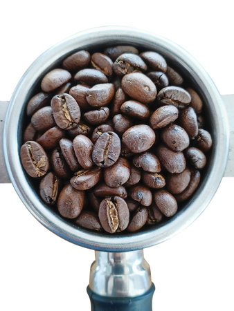 Roasted coffee beans in portafilter holder. Close upの写真素材