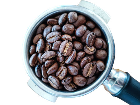 Roasted coffee beans in portafilter holder. Close upの写真素材