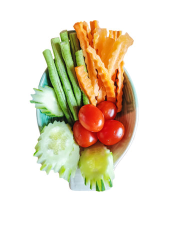 A bowl of fresh cucumbers, tomatos, string beans and carrots as a side dish (Selective Focus)の写真素材