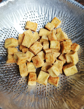 Fried Tofu in colander for Oil filter. Raw materials of vegetarian food for Vegetarian Festivalの写真素材
