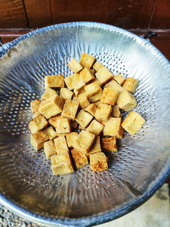 Fried Tofu in colander for Oil filter. Raw materials of vegetarian food for Vegetarian Festivalの写真素材