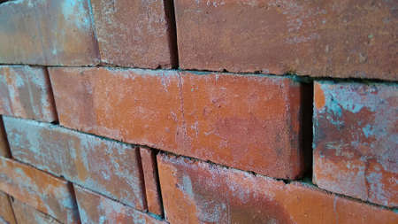 Close up view of red brick wall texture. Abstract background of a brick wall with a diminishing patternの写真素材