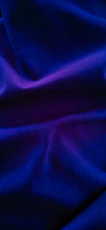 False violet-blue of desert view created from fabric fold with a dark background