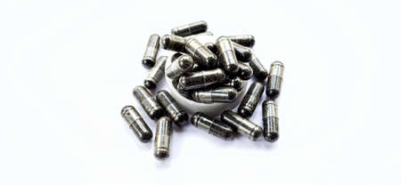 Herbal medicine black cumin capsules with negative space isolated on the gray white studio...