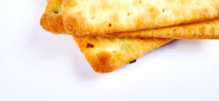 Sugarless and vegetable healthy cracker biscuit slices on the gray white studio background. Food...