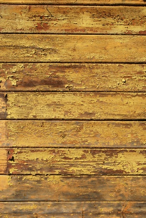 Old shabby painted yellow wooden planks textureの写真素材