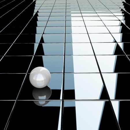 Small white sphere on a glossy black backgroundの写真素材