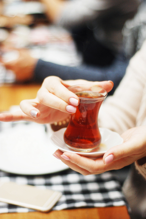 Drinking turkish tea in small glasses closeupの写真素材