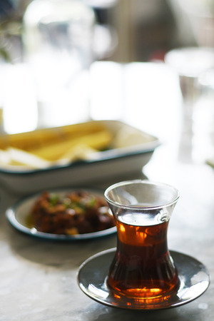 Tea in traditional turkish glass on a tableの写真素材