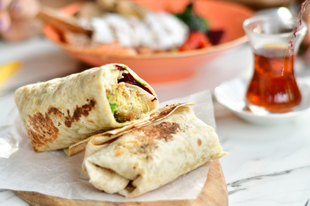 Vegetarian wrap on a wooden desk in cafe closeupの写真素材