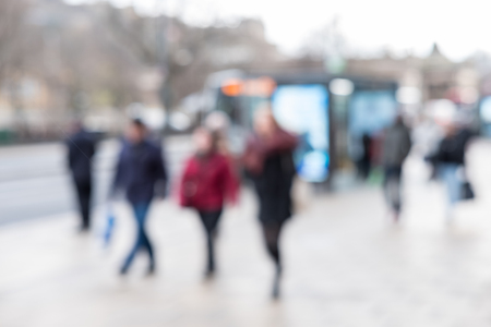 Blurred image of People walking on the street, with car, building in background.の写真素材