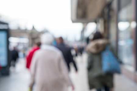 Blurred image of People walking on the street, with car, building in background.の写真素材