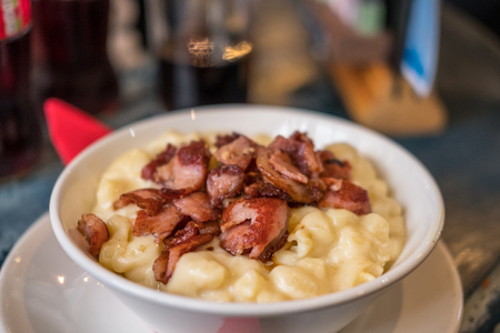 Mac and Cheese in a bowl, with bacon on the top.の写真素材