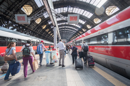Milan, Italy - 21 May 2017: Peopla walking around Milano Centrale Station with trains at platforms. It is main, central railway station of the city of Milanのeditorial素材