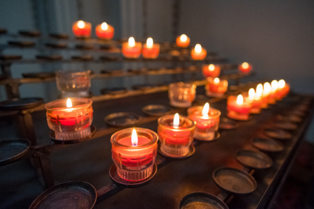 Red Burning Candles in the dark, in the Church.の写真素材
