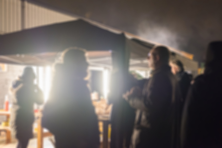 Blur image of people standing, outdoor party celebration at night.の写真素材
