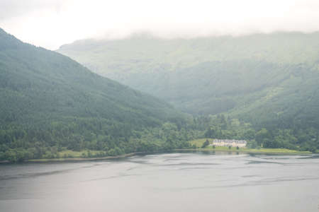 Scenic Landscape View of Mountain and house near the lake, in Scottish Highland.