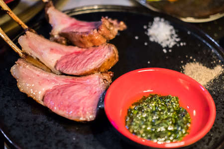 Smoked Australian lamb chops steak served on plate with sauceの写真素材