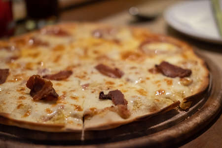 Close up of a piece of Pizza on the table.