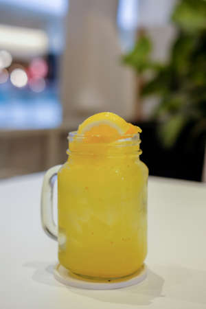 Orange juice served in a glass jar