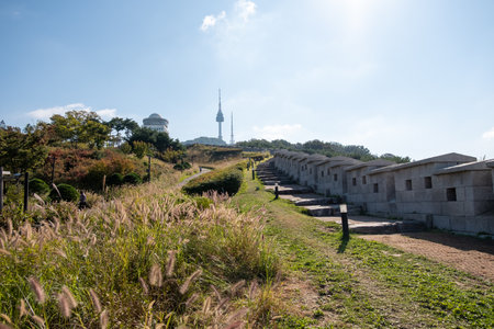Walkway next to Hanyangdoseong Wall or Seoul City Wall in Namsan park, with the view of N Seoul Tower. South Koreaの写真素材