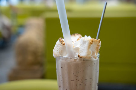 Chocolate Milk Shake with burnt marshmallow on the table, with blurred backgroundの写真素材