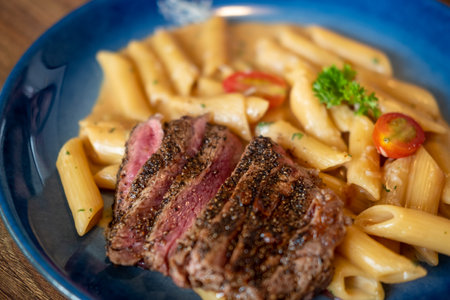 Striploin meat sliced with peanut butter hoisin sauce penneの写真素材