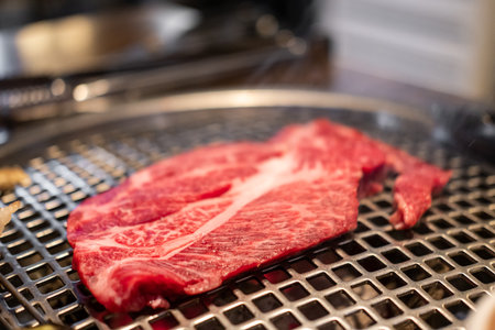 Korean Style Barbecue Grill BBQ rare meat with soft focusの写真素材