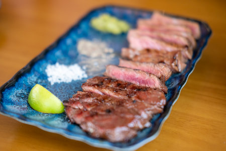 Medium rare meat on plate with salt and pepperの写真素材