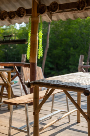 Chairs and wooden tables by the canal, the local lifestyle.の写真素材
