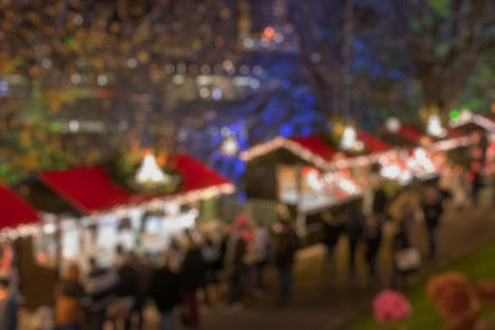 Blurred image bokeh of People walking, shopping at Edinburgh Christmas Market. New Year.の写真素材