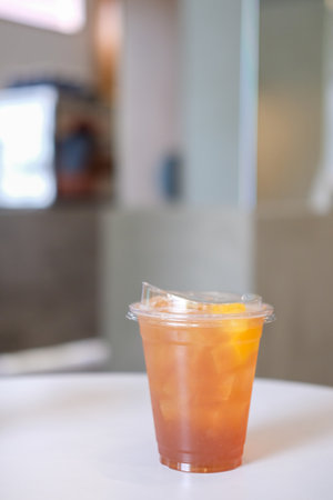 A cup of peach tea on the tableの写真素材