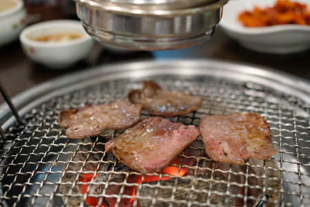 Korean Style Barbecue Grill BBQ rare beef tongue meat with soft focusの写真素材