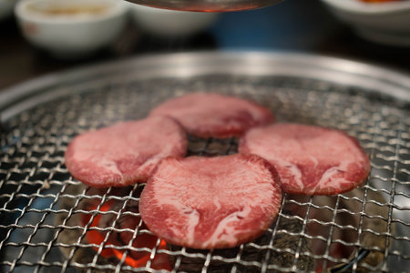 Korean Style Barbecue Grill BBQ rare beef tongue meat with soft focusの写真素材