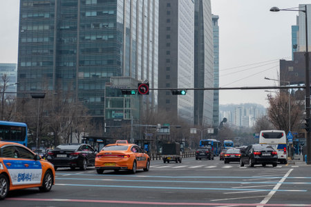 Seoul, South Korea - 18 February 2023: Car on the road next to Gwanghwamun Square, in front of Gyeongbokgung Palace. It is a public square located at the centre of Sejong-ro roadのeditorial素材