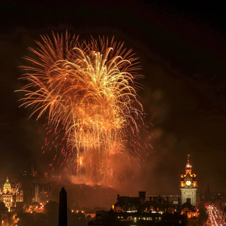 Fireworks over Edinburgh Castle with view of the city. Finale of Edinburgh International Festival in United Kingdom.の写真素材
