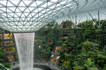 Singapore - 22 October 2022: The world's tallest indoor waterfall at Jewel Changi Airport. It is a nature-themed entertainment and retail complex surrounded by and linked to Changi Airportのeditorial素材