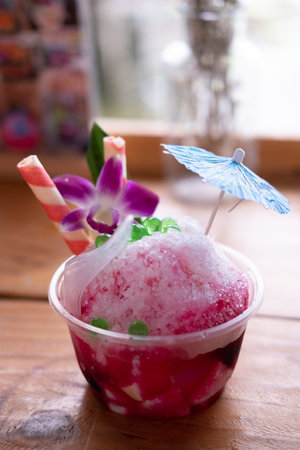 Shaved ice with red syrup with toppingの写真素材