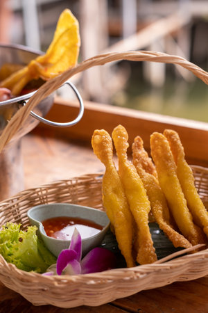 Fried wontons with minced pork meat served in the basket with sauceの写真素材