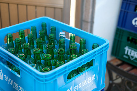 Seoul, South Korea - 13 October 2022 : Beer crate with empty bottles of soju. It is a famous clear, colorless distilled beverage of Korean originのeditorial素材